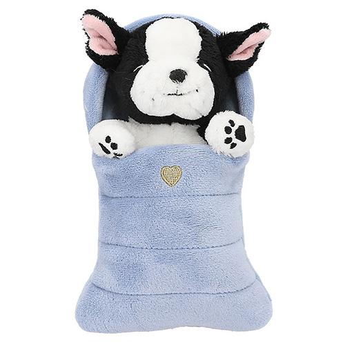 Top Model black and white plush dog in a blue sleeping bag