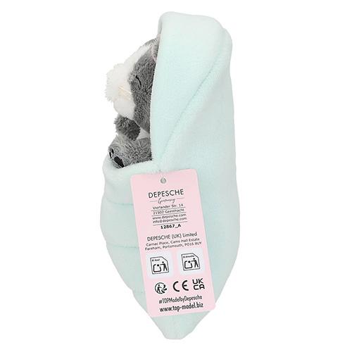 Top Model gray plush cat in a green sleeping bag
